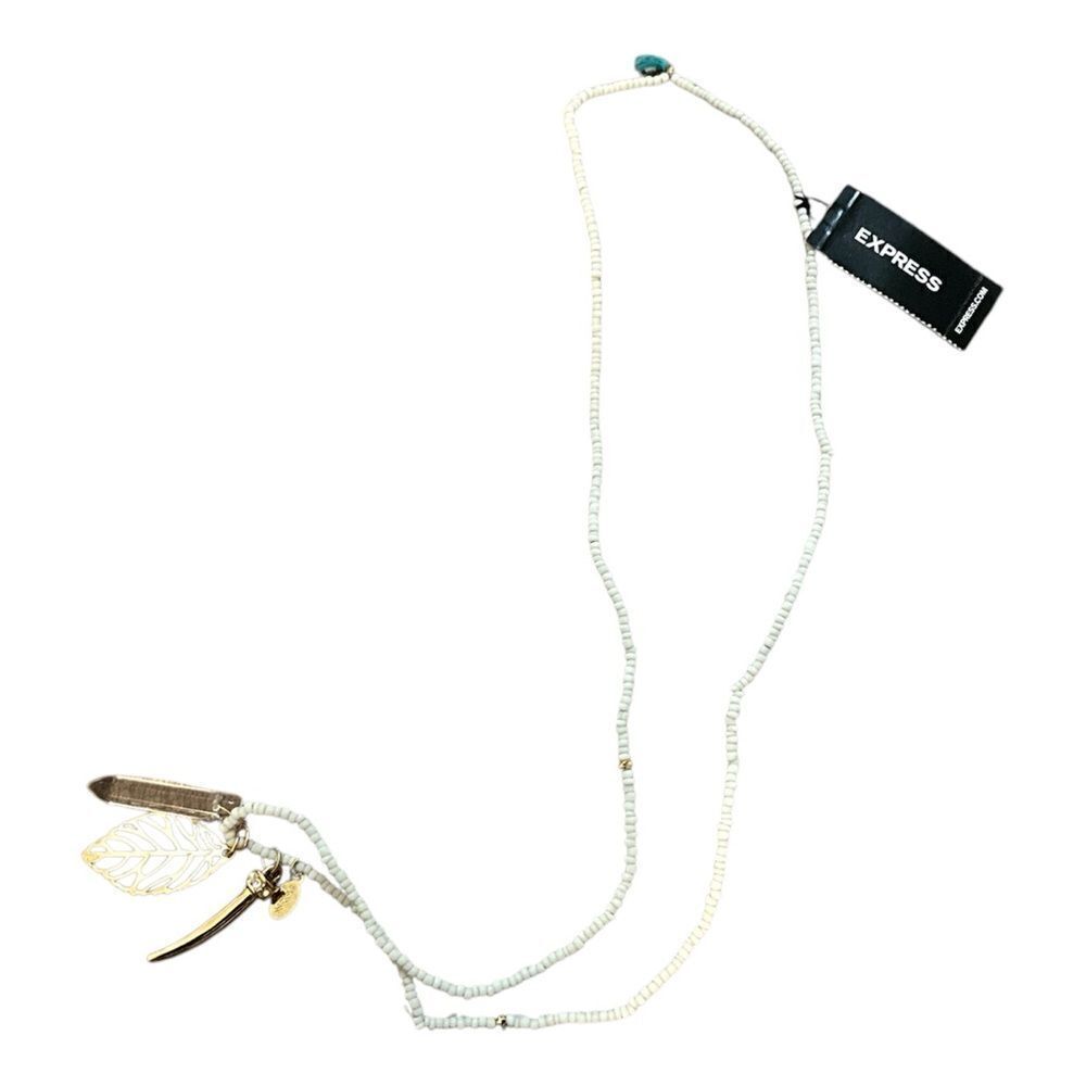 Express white beaded necklace with gold tone pendants. NWT